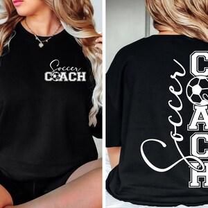 May include: Black t-shirt with white text that says "Soccer Coach" on the front and "Soccer COACH" with a football on the back.