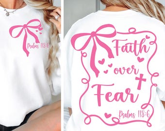 May include: White sweatshirt with a pink bow and the text "Faith over Fear" with a cross and the scripture "Psalms 118:6".