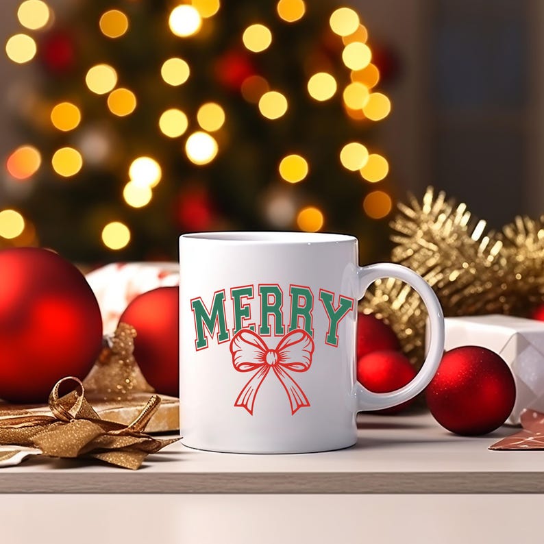 May include: White ceramic mug with a green and red "Merry" design and a red bow.
