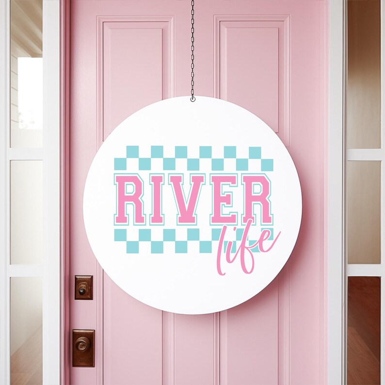 May include: A white round sign with a pink checkered pattern and the text "River life" in pink lettering.