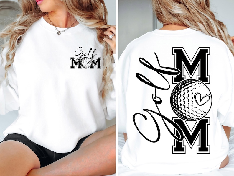 Może przedstawiać: Biała bluza z napisem "Golf Mom" i grafiką piłki golfowej z przodu. Z tyłu bluzy znajduje się napis "Golf" kursywą i duża litera "M" z grafiką piłki golfowej i sercem.