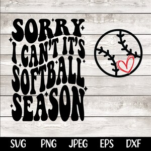 May include: Black and white graphic design with the text "Sorry I can't it's softball season" in a retro font. A black and white softball with a red heart is on the right side of the design.