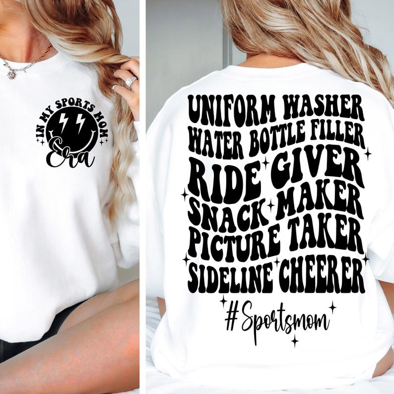 May include: White sweatshirt with black text that reads "In My Sports Mom Era" with a smiley face and lightning bolts. The back of the sweatshirt has black text that reads "Uniform Washer, Water Bottle Filler, Ride Giver, Snack Maker, Picture Taker, Sideline Cheerer, #Sportsmom".