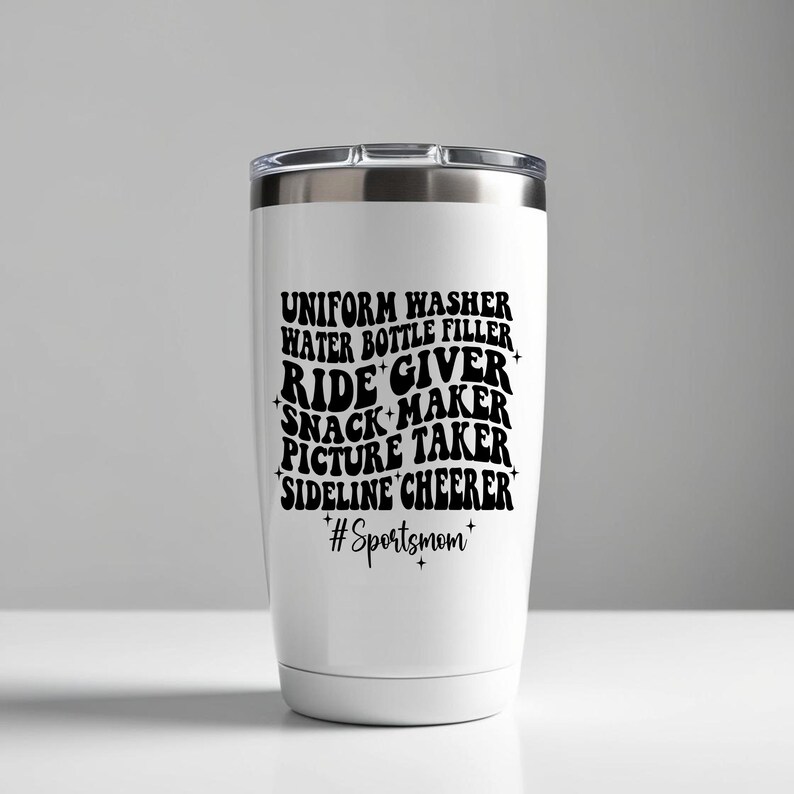 May include: White stainless steel tumbler with a black graphic that reads "Uniform Washer, Water Bottle Filler, Ride Giver, Snack Maker, Picture Taker, Sideline Cheer, #Sportsmom".