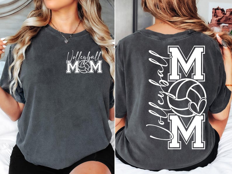 May include: A dark gray t-shirt with the text "Volleyball Mom" and a volleyball graphic on the front. The back of the shirt has the text "Volleyball Mom" with a volleyball and heart graphic.