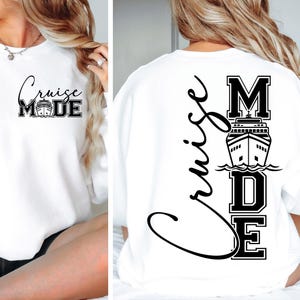 以下が含まれることがあります： 黒いスクリプトとブロック文字で「Cruise Mode」という言葉が入った白いスウェットシャツ。前面にはテキストとクルーズ船のグラフィックがあります。背面には「Cruise」の文字が縦に、「MODE」の文字とクルーズ船があります。