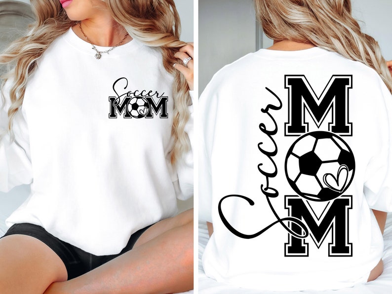 May include: White sweatshirt with black text that says "Soccer Mom" with a soccer ball in the middle of the word "Mom". The back of the sweatshirt has the word "Soccer" written in cursive with a large black "M" with a soccer ball inside and a smaller black "M" below the soccer ball.