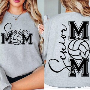 May include: Gray sweatshirt with the text "Senior Mom" and a volleyball graphic on the front. The back of the sweatshirt has the text "Senior Mom" with a volleyball graphic and a heart.