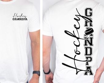 May include: White t-shirt with the text "Hockey Grandma" in black script on the front. The back of the shirt features the word "Hockey" in script and "Grandpa" in block letters with a hockey puck graphic.