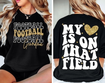 May include: Black sweatshirt with the words "FOOTBALL FOOTBALL FOOTBALL Grandma" in white and gold glitter lettering on the front. The back of the shirt says "MY HEART IS ON THAT FIELD" with a gold glitter heart.