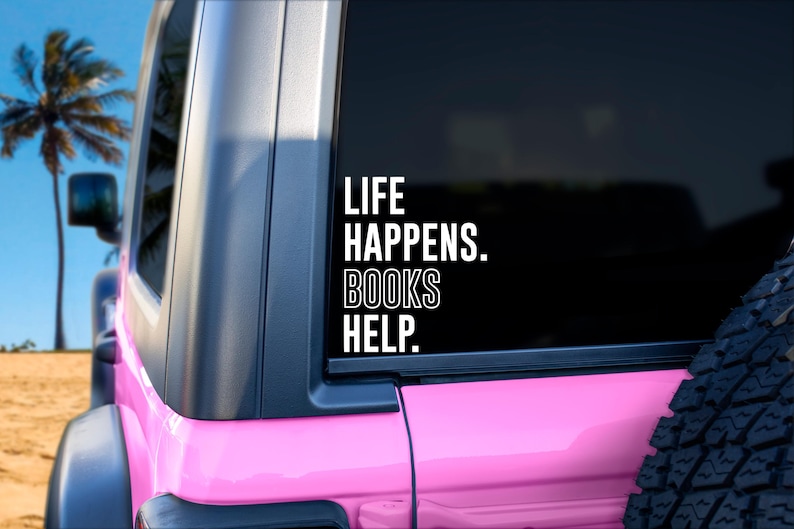 May include: A pink Jeep with a white vinyl sticker on the back window that reads "Life Happens. Books Help."