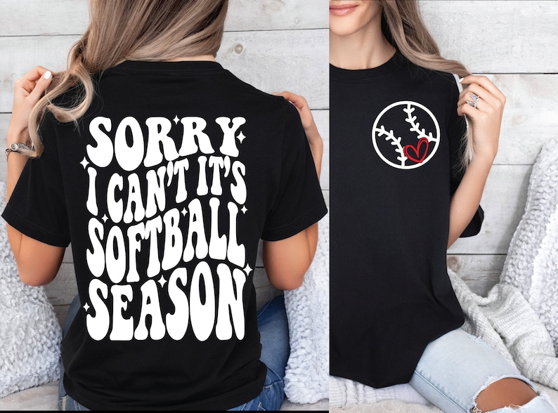 May include: Black t-shirt with white text that reads "Sorry I can't it's softball season". The back of the shirt has a white baseball with a red heart in the middle.