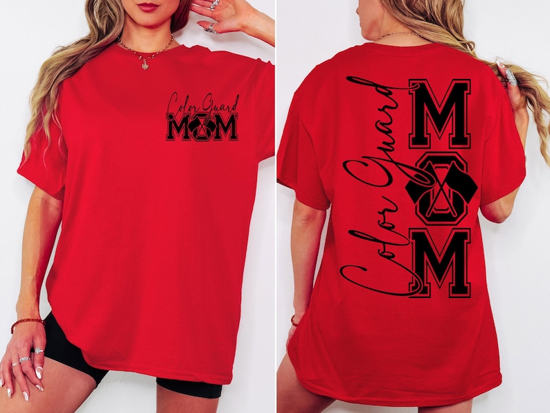 May include: Red t-shirt with black text that says "Color Guard Mom" on the front and "Color Guard MOM" vertically down the back with a graphic of crossed flags.