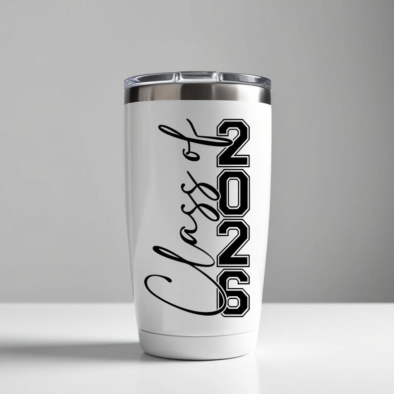 May include: White insulated tumbler with a silver lid. The tumbler features the words "Class of 2026" in black script and block letters. The tumbler is designed to keep beverages hot or cold.
