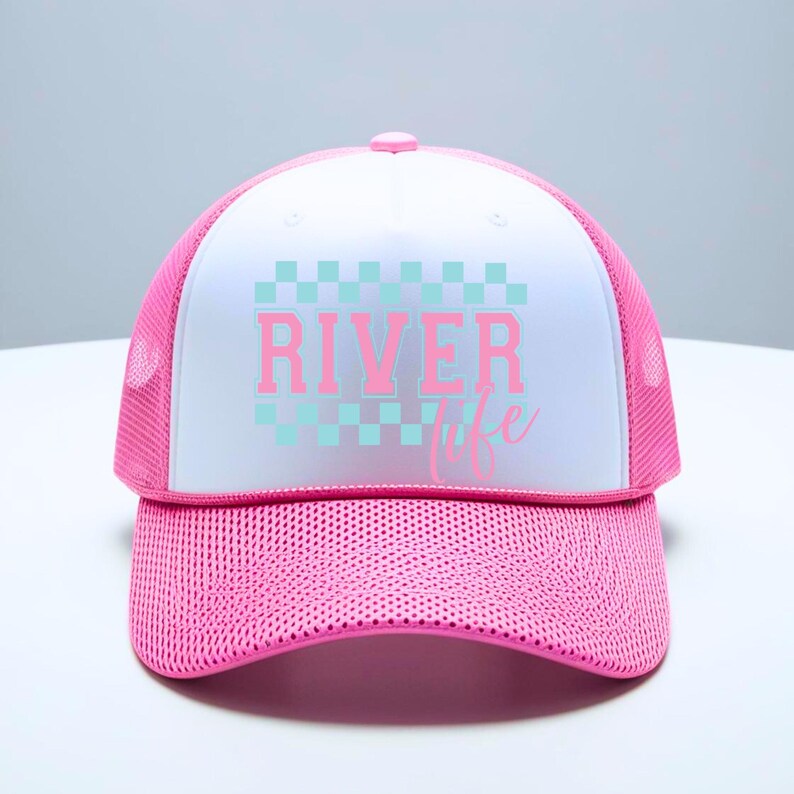 May include: A pink and white trucker hat with a checkered pattern and the text "River Life" in pink letters.