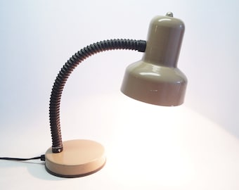 A mid-century modern light brown/beige desk lamp.