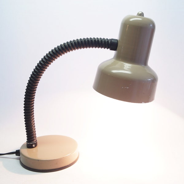 A mid-century modern light brown/beige desk lamp.