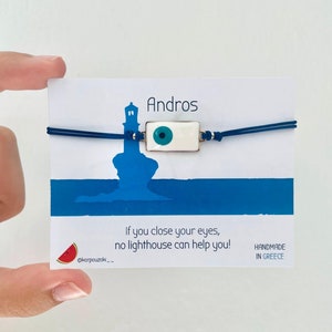 May include: Blue and white evil eye charm bracelet with a lighthouse charm and the text "Andros" and "If you close your eyes, no lighthouse can help you!"  Handmade in Greece.