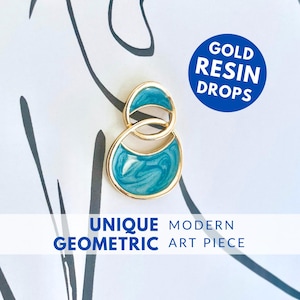 May include: Gold resin drops in a unique modern geometric design. The resin is a teal blue color with a marbled effect.