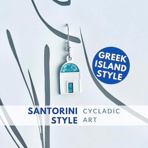 May include: A silver earring with a white and turquoise design in the shape of a Greek island building. The earring is suspended from a silver hook. The text "Greek Island Style" and "Santorini Cycladic Style Art" are also visible.