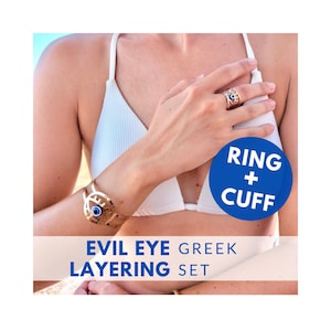 May include: Gold-toned ring and cuff bracelet set with an evil eye design. The ring is on a finger, and the cuff is on a wrist. The evil eye has blue and white accents. The text "RING + CUFF" is on a blue circle. The text "EVIL EYE GREEK LAYERING SET" is below.