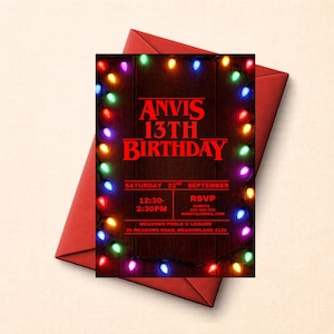 May include: A rectangular birthday invitation card featuring a dark wood grain background framed by colorful glowing string lights. The text reads ANVIS 13TH BIRTHDAY, SATURDAY 22ND SEPTEMBER, 12:30-2:30PM, RSVP NAMITA 024 000 000, and MEADOWS POOLS & LEISURE.