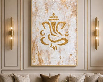 May include: A rectangular wall art piece featuring a gold-toned Ganesha silhouette centered on a textured white and gold abstract background, framed in a thin gold border and displayed above a beige sofa in a living room setting.
