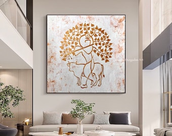 May include: Gold leaf painting on canvas depicting a stylized figure holding a flute, standing on a cow, with a tree behind them. The background is a white textured surface.