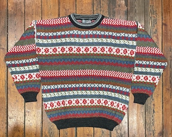 May include: A multi-colored striped sweater with a fair isle pattern. The sweater has a crew neck and is made of a soft, warm material.
