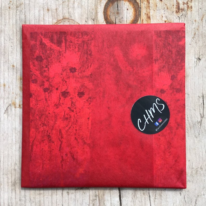 May include: Red paper gift wrap with a black circle sticker that says "CHMS" with a social media icon and the text "@chmsmerch" on it.