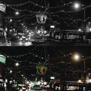 May include: A black and white photo of a city street at night, decorated with Christmas lights. The photo is split in half, with the top half showing the street in black and white, and the bottom half showing the street in color. The street is lined with buildings, and there are cars parked on both sides of the street. The street is decorated with Christmas lights, which are strung across the street and from the buildings. The lights are twinkling, and they create a festive atmosphere.