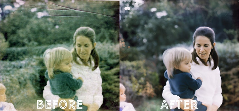 May include: A woman in a white shirt is holding a child in a blue sweater. The woman is smiling and looking at the child. The child is looking at the camera. The background is a blurry green.