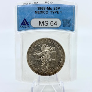 May include: A silver 1968-Mo 25P Mexico Type 1 coin, graded MS 64 by ANACS, encased in a clear plastic holder. The coin features an Olympic athlete design with the text "JUEGOS DE LA XIX OLIMPIADA MEXICO 1968".