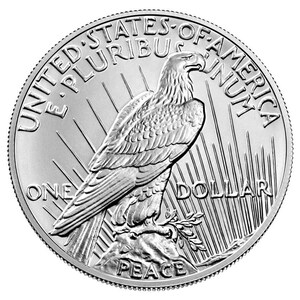 May include: A silver United States Peace Dollar coin with an eagle perched on a rock, holding an olive branch in its talons. The coin features the inscription "United States of America" and "E Pluribus Unum" above the eagle, and "One Dollar" and "Peace" below the eagle.