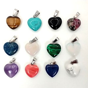 May include: Twelve heart-shaped pendants made of various gemstones, including turquoise, tiger's eye, black onyx, amethyst, and rose quartz. Each pendant is attached to a silver bail.