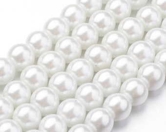 May include: A strand of white pearl beads. The beads are round and smooth, and they are strung together on a clear thread.