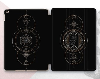 May include: A black iPad case with a geometric owl design in gold and white. The owl is surrounded by circles and stars. The case has a black background and a gold trim.