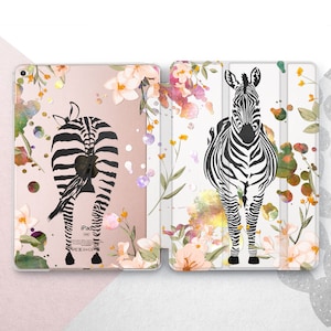 May include: A pink and white iPad case with a floral pattern and black and white zebra silhouettes. The case has a flap that covers the screen and a cutout for the iPad's camera.