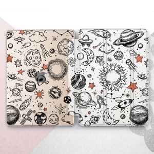 May include: Two iPad cases featuring a space-themed design. The cases are white with black line drawings of planets, stars, rockets, and other space-related objects.