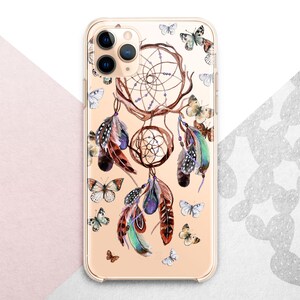May include: A clear phone case with a gold background and a dreamcatcher design. The dreamcatcher is decorated with feathers and butterflies in shades of brown, blue, and white.