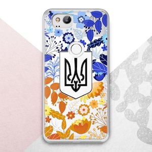 May include: A clear smartphone case featuring a central black Ukrainian trident emblem on a white shield. The design is surrounded by a vibrant floral pattern with blue, light blue, orange, and yellow flowers and leaves on a transparent background.