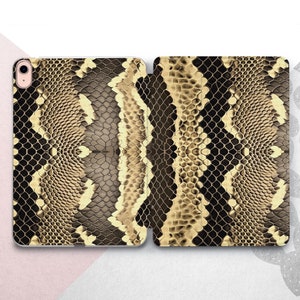 May include: A brown and gold snakeskin patterned iPad case with a cutout for the camera lens.