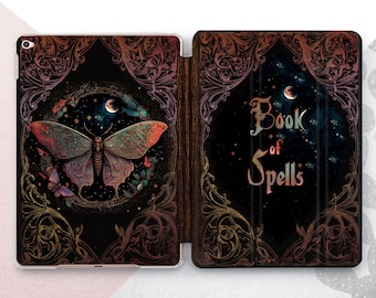 May include: A black iPad case with a vintage design featuring a moth with iridescent wings, a crescent moon, and stars. The text "Book of Spells" is printed on the case.