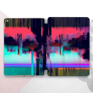 May include: A black and blue iPad case with a colorful abstract design featuring pink, blue, and green hues. The case has a textured surface and a flap that covers the screen.
