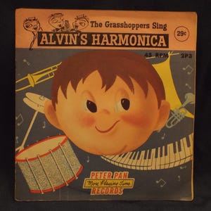 May include: Vintage vinyl record album cover for "Alvin's Harmonica" by Peter Pan Records. The cover features a cartoon illustration of a smiling boy with brown hair, musical instruments, and the text "The Grasshoppers Sing".