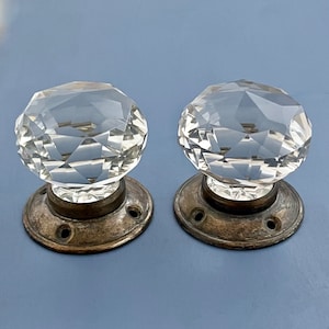 May include: Two antique door knobs with faceted crystal glass knobs and brass bases.