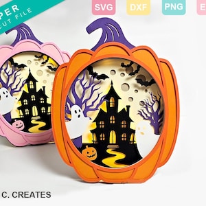 May include: Two Halloween-themed pumpkin-shaped papercraft decorations. The pumpkins are orange and pink with a cut-out design of a spooky house, ghosts, and bats. The text "PAPER SVG CUT FILE" is in the top left corner of the image.