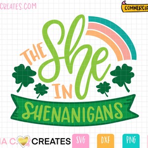 Pode incluir: Design de trevo verde com um arco-íris e o texto "The She-nanigans" em uma faixa verde.