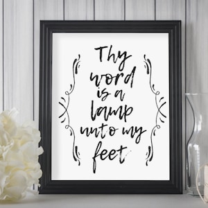 May include: Black and white framed print with the text "Thy word is a lamp unto my feet". The print is on a white background and has a decorative border.