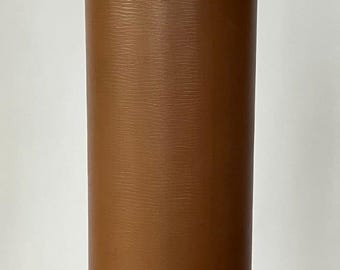 May include: A cylindrical table lamp with a brown textured shade and a brass base and hardware. The lamp has a classic design and is suitable for a living room or bedroom. The lamp is approximately 24 inches tall.